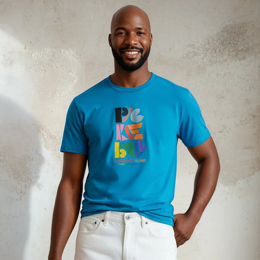 Man wearing a blue t-shirt with colorful text design against a textured wall.