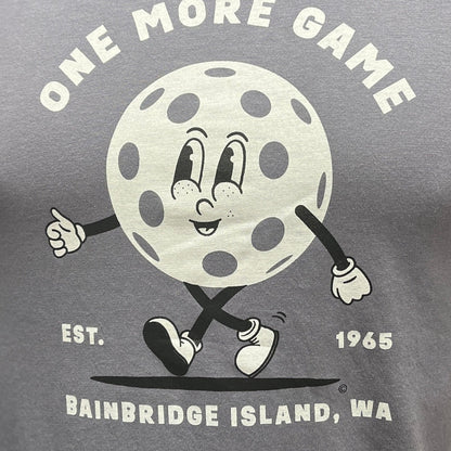 Gray ONNO bamboo t-shirt with a graphic print of a pickleball character and text 'ONE MORE GAME EST. 1968 Bainbridge Island, WA'.